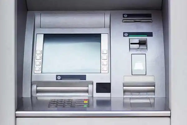 ATM machine interface with a screen, keypad, and card reader.