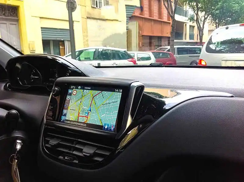 GPS navigation system mounted on a vehicle’s dashboard displaying a digital map.