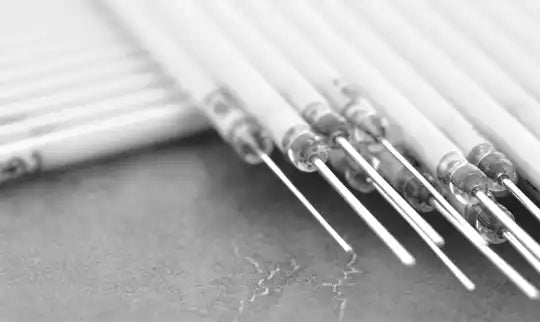 Several medical syringes lined up in a row.