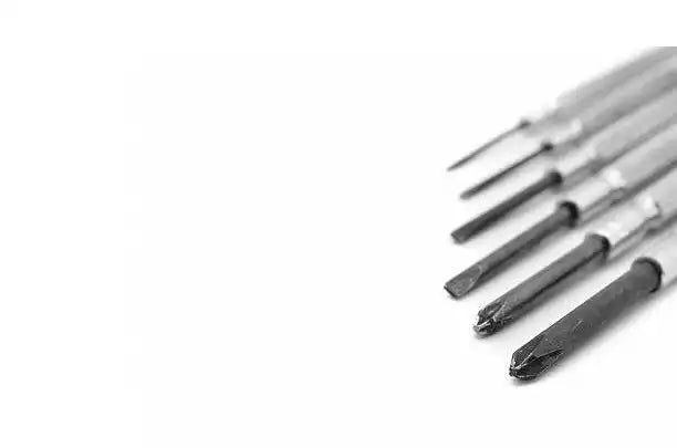 Screwdriver bits arranged in a diagonal line.